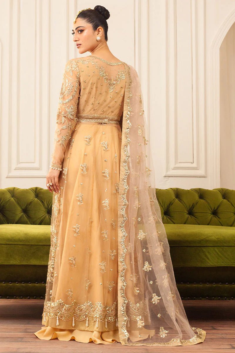 Model wearing a soft chamois wedding formal dress from Mushq, featuring intricate embellishments. Pakistani wedding clothes online in the UK.