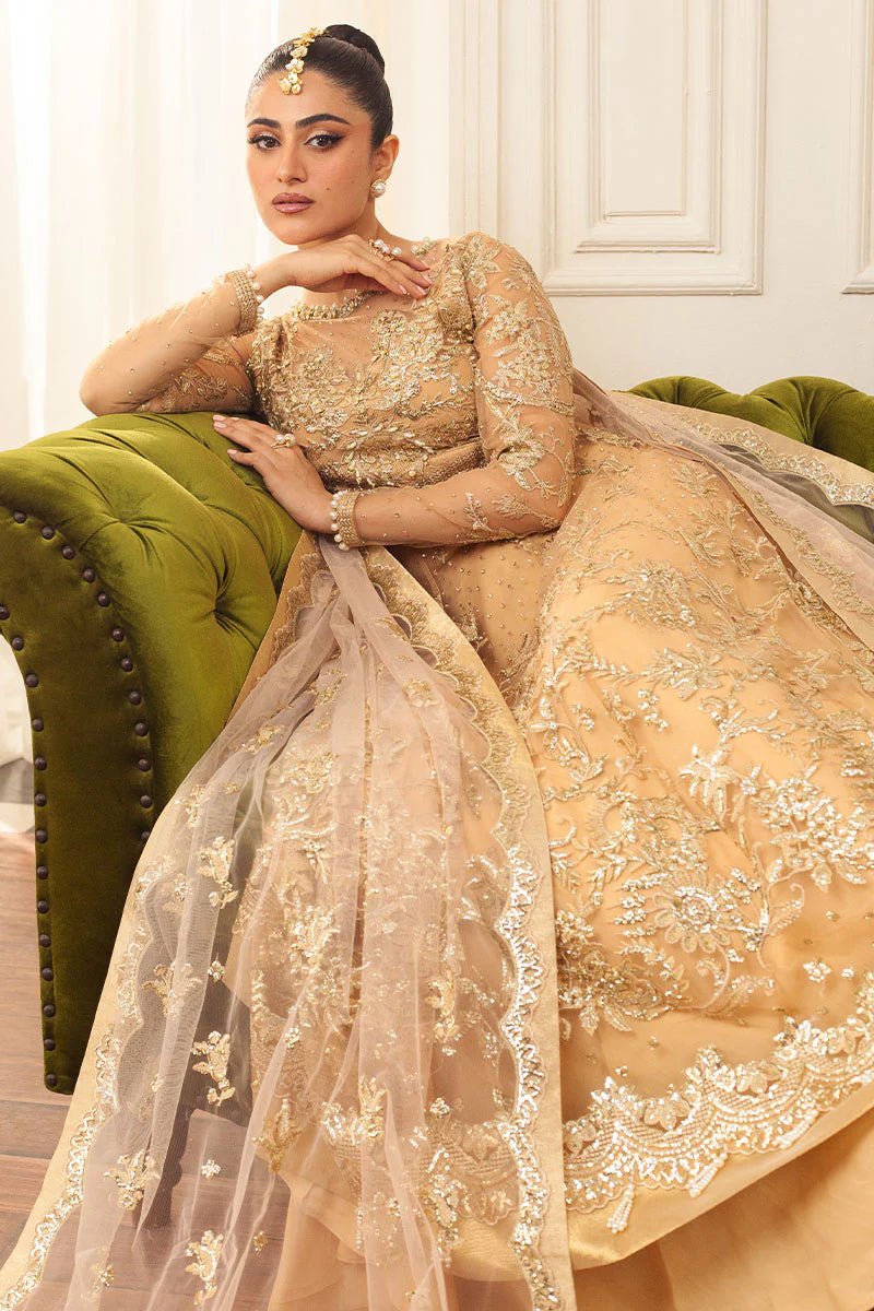 Model wearing a soft chamois wedding formal dress from Mushq, featuring intricate embellishments. Pakistani wedding clothes online in the UK.