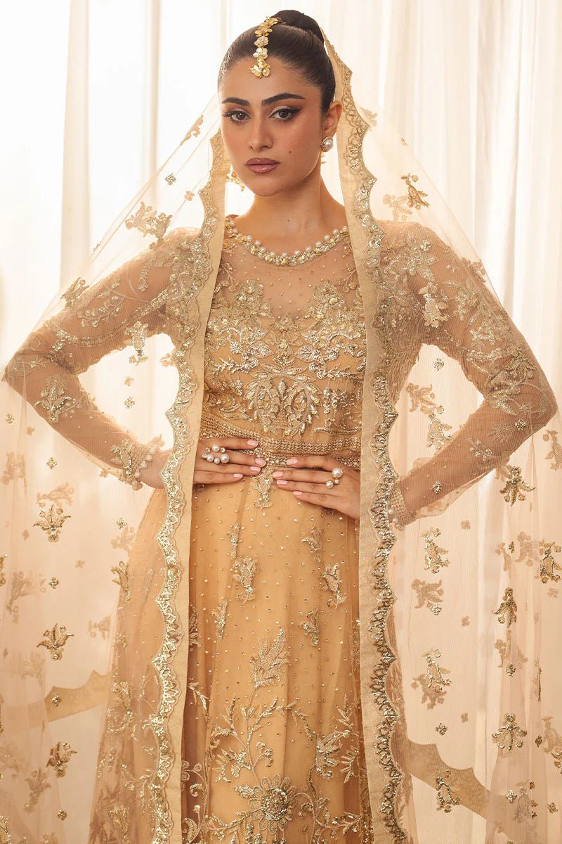 Model wearing a soft chamois wedding formal dress from Mushq, featuring intricate embellishments. Pakistani wedding clothes online in the UK.