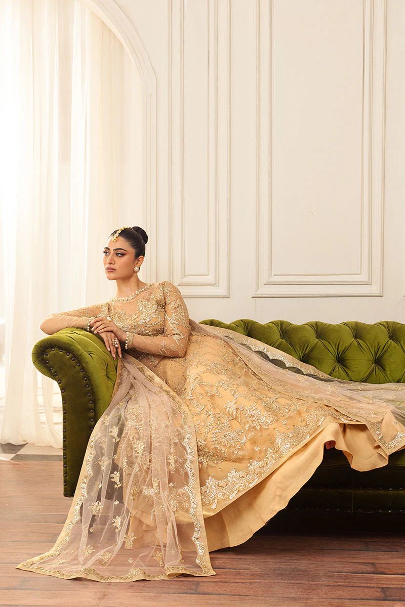 Model wearing a soft chamois wedding formal dress from Mushq, featuring intricate embellishments. Pakistani wedding clothes online in the UK.