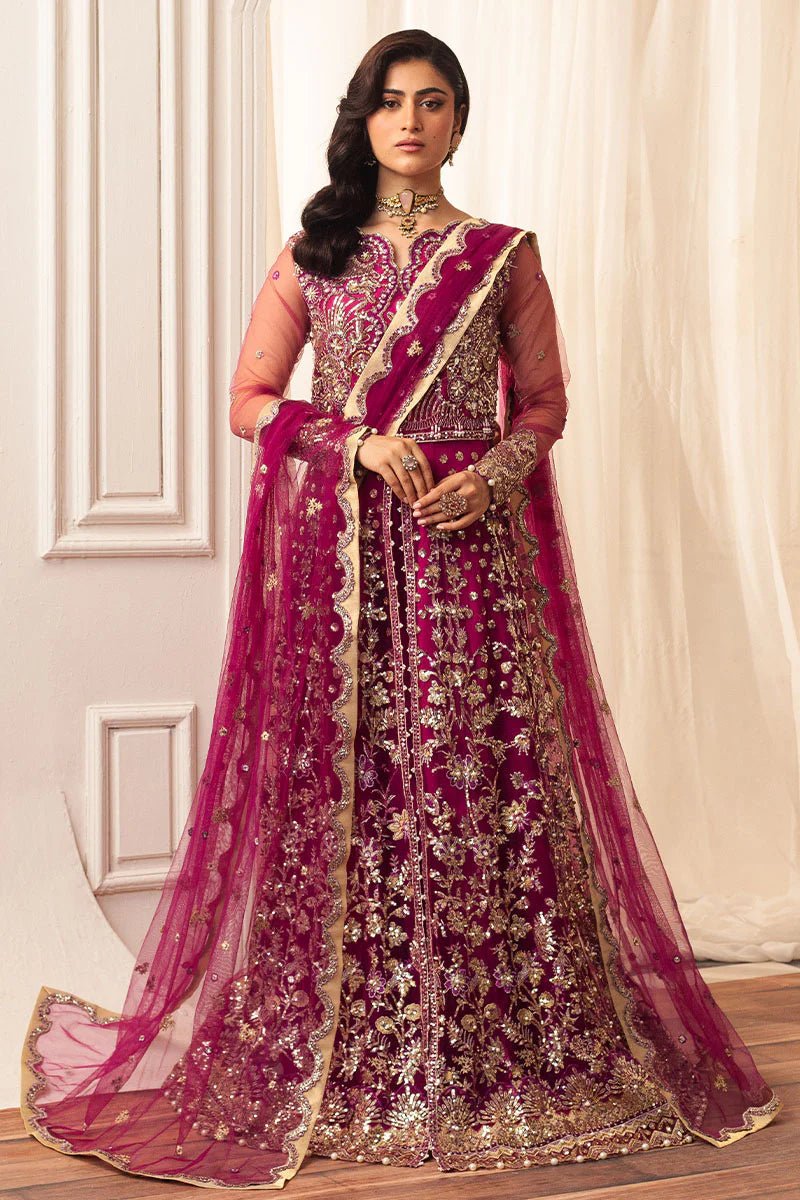 Model wearing a vibrant fuchsia wedding formal dress from Mushq. Pakistani wedding clothes online in the UK.