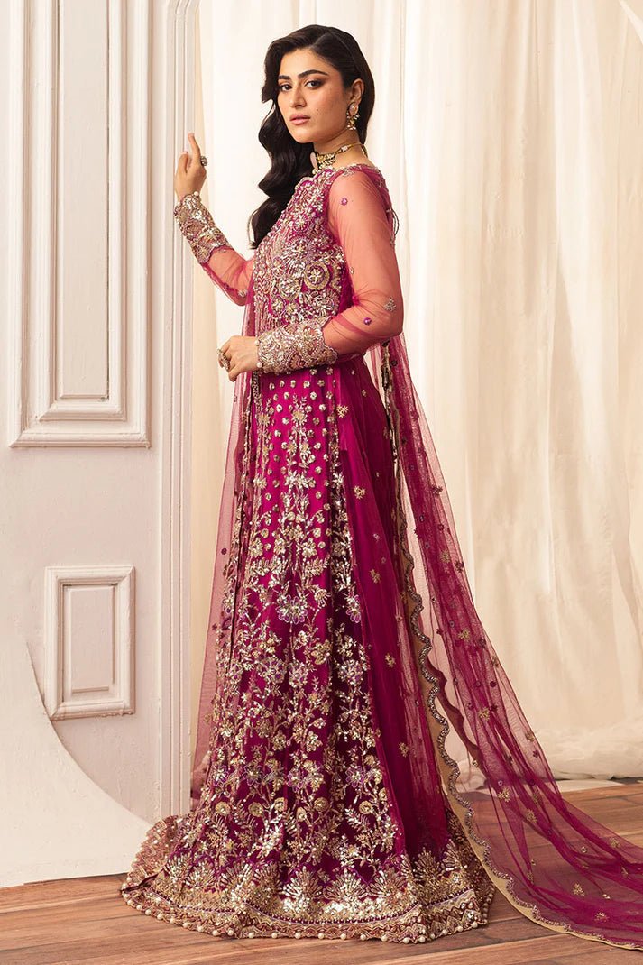 Model wearing a vibrant fuchsia wedding formal dress from Mushq. Pakistani wedding clothes online in the UK.