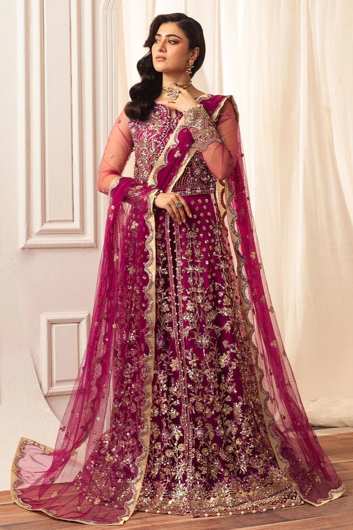 Model wearing a vibrant fuchsia wedding formal dress from Mushq. Pakistani wedding clothes online in the UK.