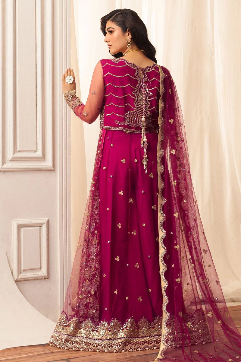 Model wearing a vibrant fuchsia wedding formal dress from Mushq. Pakistani wedding clothes online in the UK.