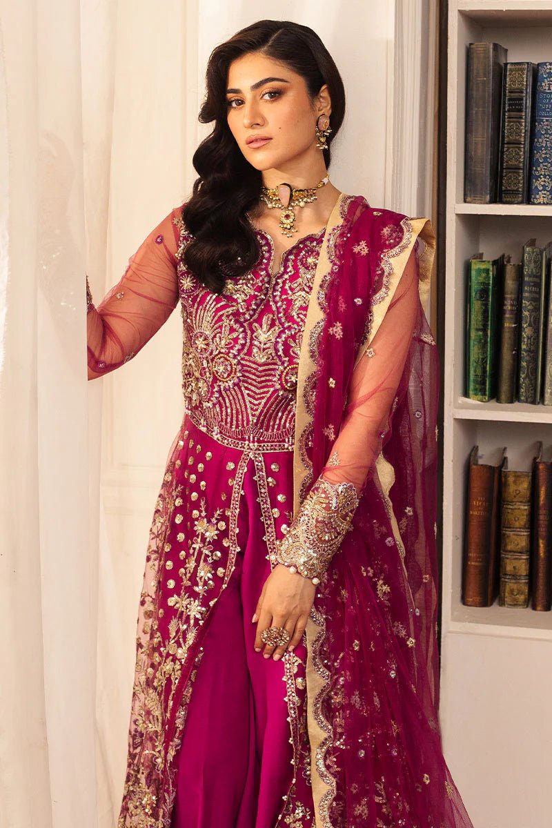 Model wearing a vibrant fuchsia wedding formal dress from Mushq. Pakistani wedding clothes online in the UK.