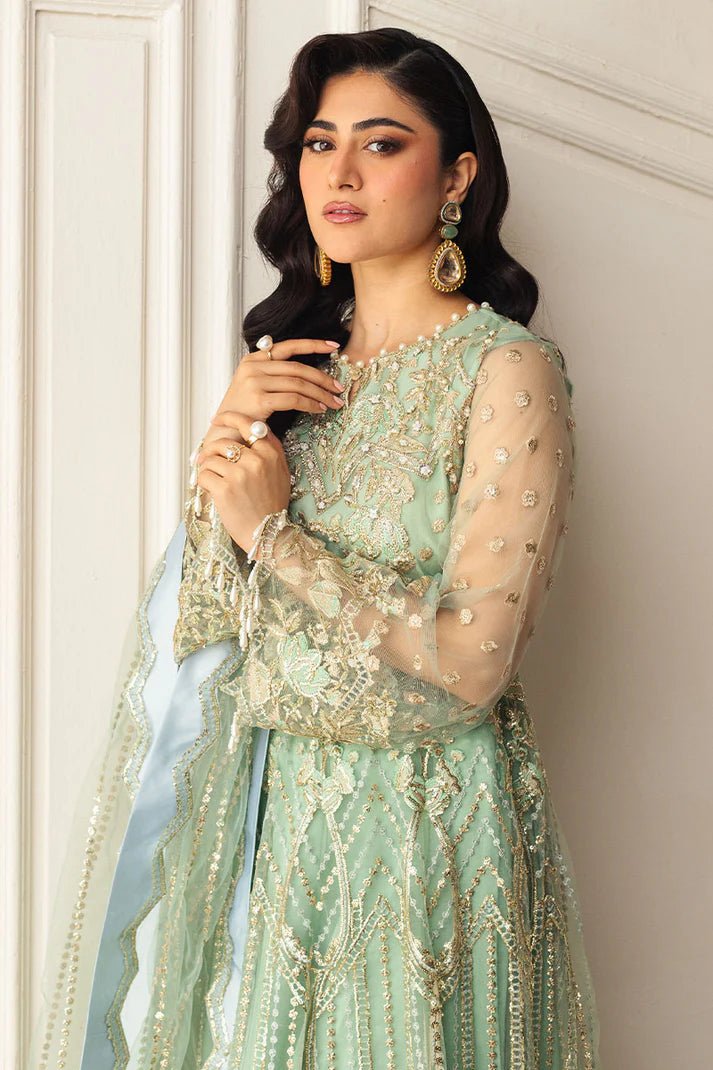 Model wearing a light pistachio green embellished wedding formal dress from Mushq. Pakistani wedding clothes online in the UK.