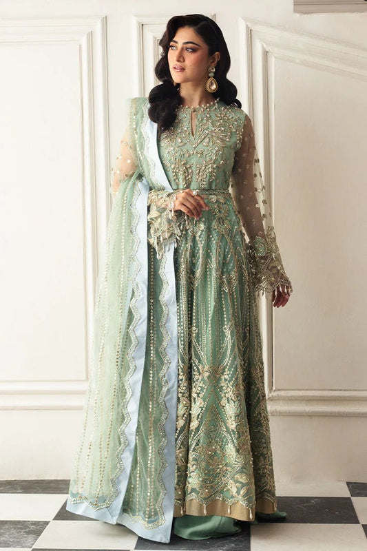 Model wearing a light pistachio green embellished wedding formal dress from Mushq. Pakistani wedding clothes online in the UK.