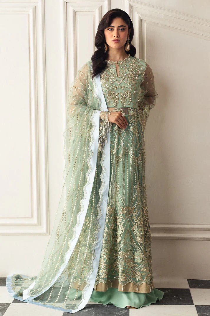 Model wearing a light pistachio green embellished wedding formal dress from Mushq. Pakistani wedding clothes online in the UK.