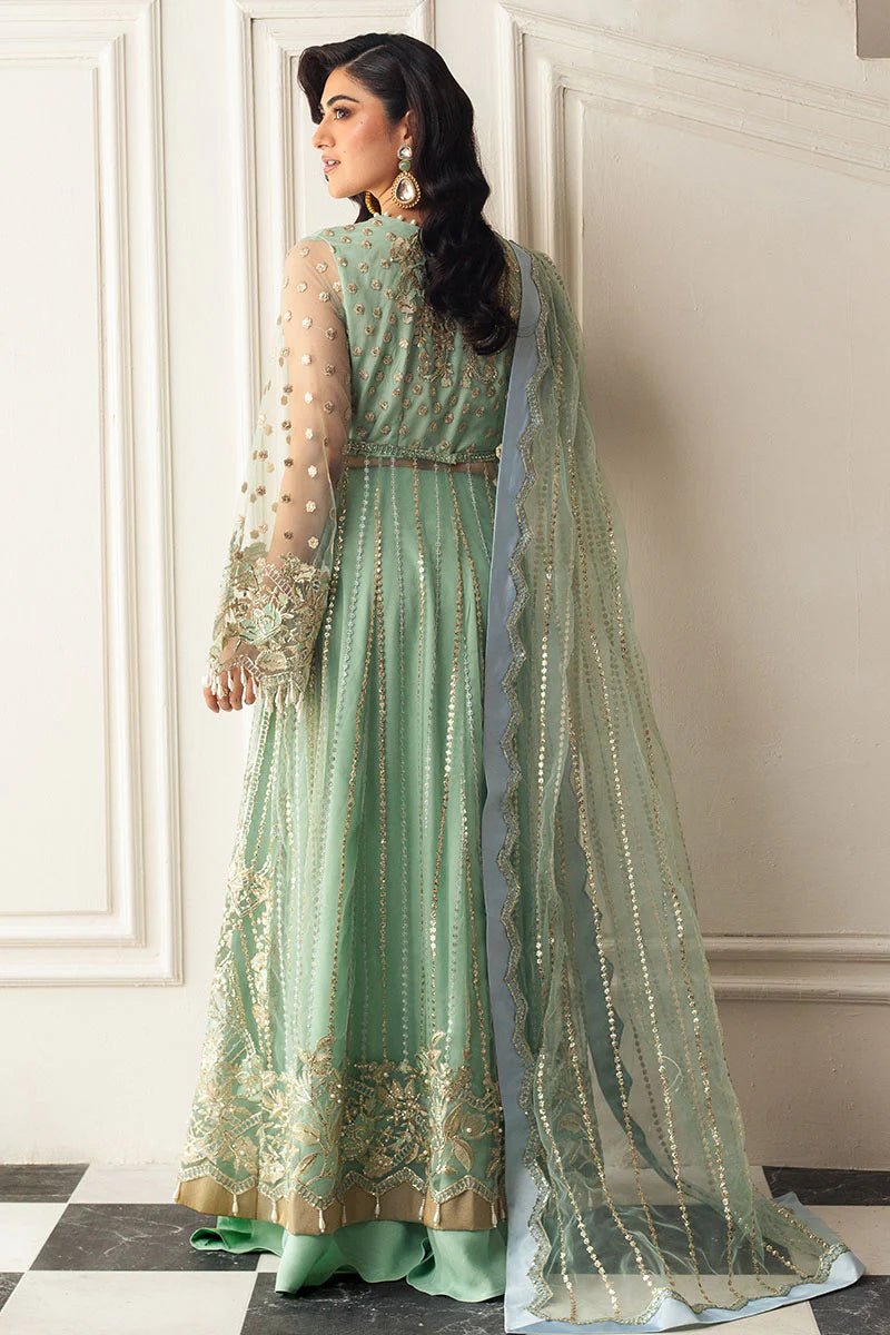 Model wearing a light pistachio green embellished wedding formal dress from Mushq. Pakistani wedding clothes online in the UK.