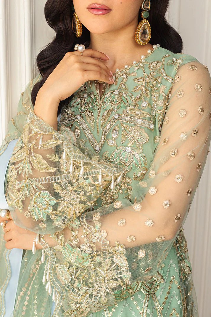 Model wearing a light pistachio green embellished wedding formal dress from Mushq. Pakistani wedding clothes online in the UK.