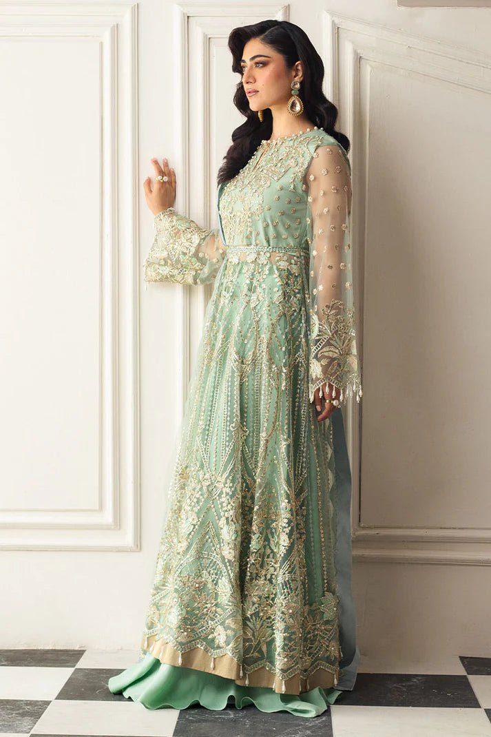 Model wearing a light pistachio green embellished wedding formal dress from Mushq. Pakistani wedding clothes online in the UK.