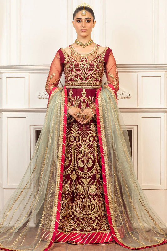 Model wearing a deep red and gold intricately embroidered Asian wedding formal dress, "Scarlet," from Mushq. Pakistani wedding clothes online in the UK.