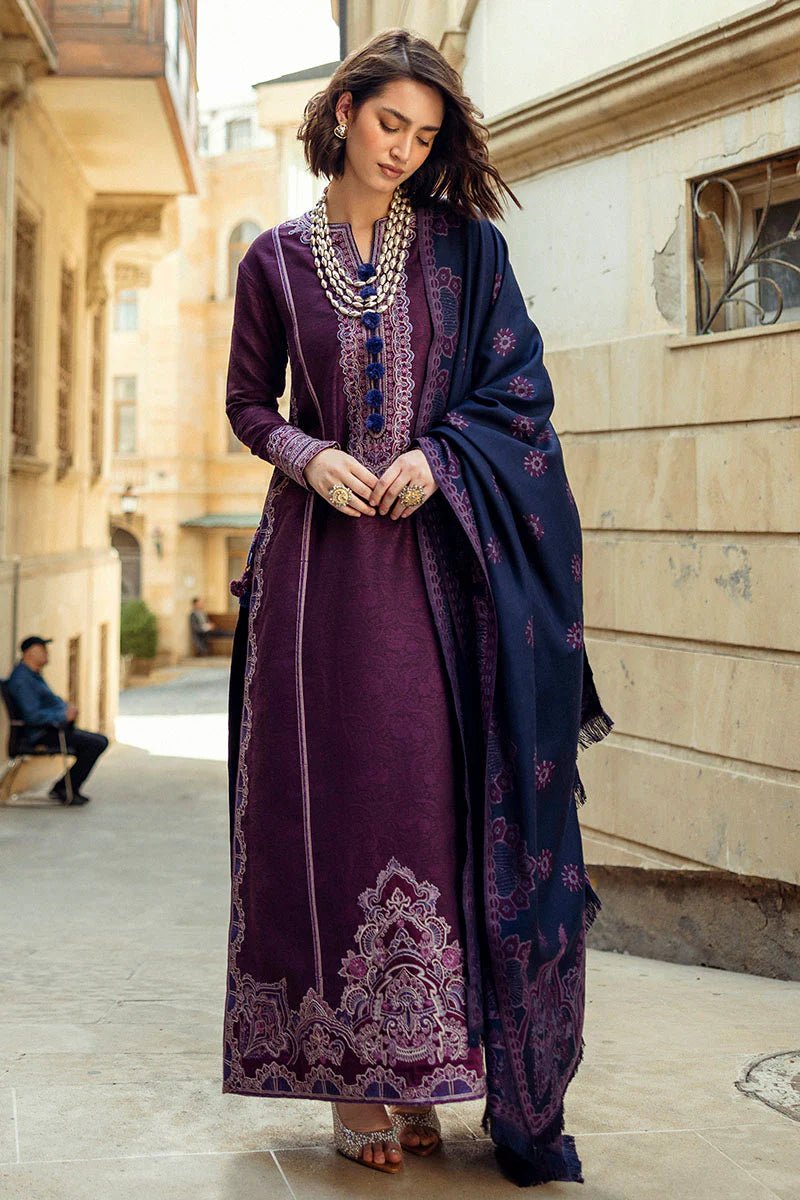 Model wearing Mushq Broadway A Walk to Remember Endless Passion, a deep purple dress with intricate embroidery and a navy patterned shawl, ideal for winter casual wear. Available for Pakistani clothes online in the UK.