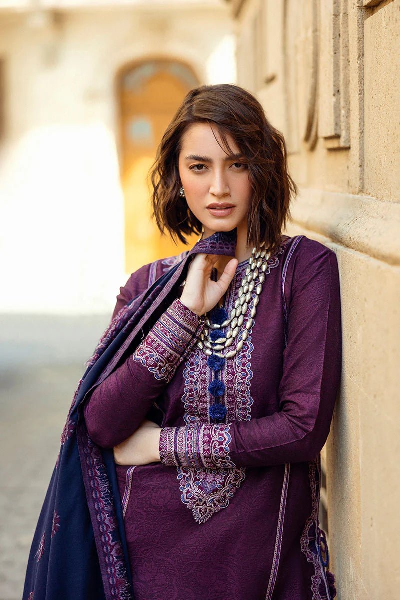 Model wearing Mushq Broadway A Walk to Remember Endless Passion, a deep purple dress with intricate embroidery and a navy patterned shawl, ideal for winter casual wear. Available for Pakistani clothes online in the UK.