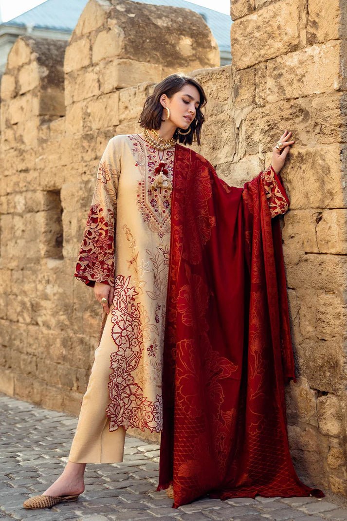 Model wearing Mushq Broadway A Walk to Remember Fallen Hearts, a beige dress with red floral embroidery and matching red shawl, perfect for winter casual wear. Available for Pakistani clothes online in the UK.