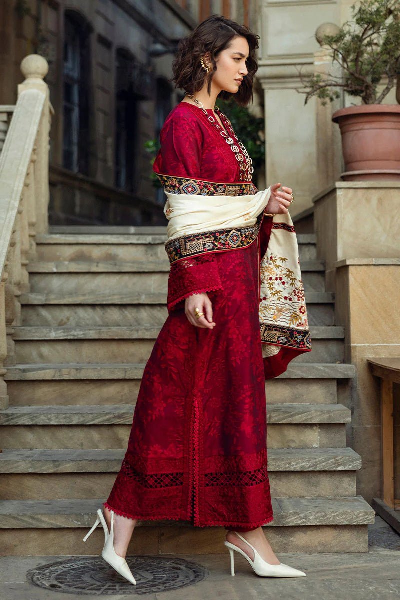 Model wearing Mushq Broadway A Walk to Remember Flying Kiss, a rich red dress with intricate patterns and a cream shawl, ideal for winter casual wear. Available for Pakistani clothes online in the UK.