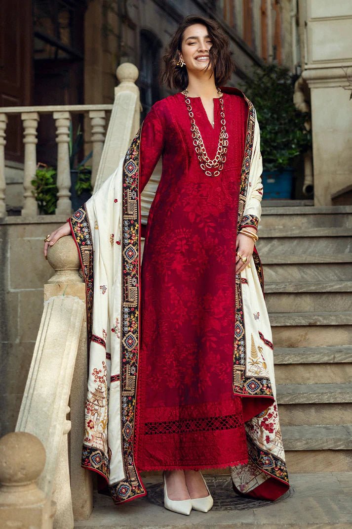 Model wearing Mushq Broadway A Walk to Remember Flying Kiss, a rich red dress with intricate patterns and a cream shawl, ideal for winter casual wear. Available for Pakistani clothes online in the UK.