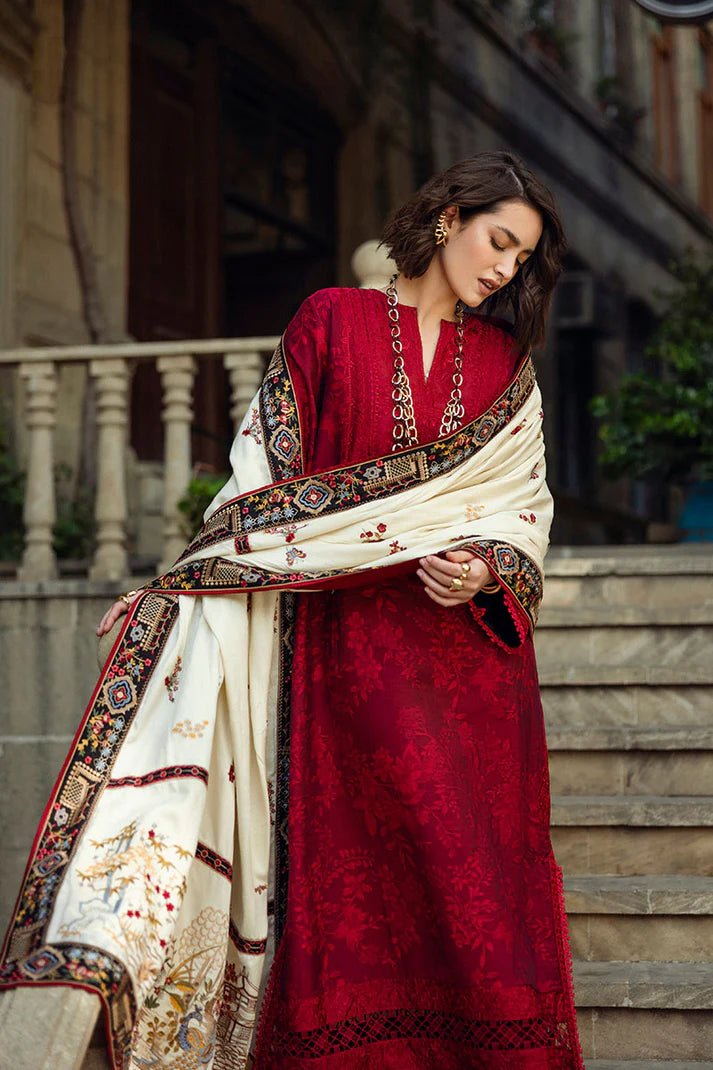 Model wearing Mushq Broadway A Walk to Remember Flying Kiss, a rich red dress with intricate patterns and a cream shawl, ideal for winter casual wear. Available for Pakistani clothes online in the UK.