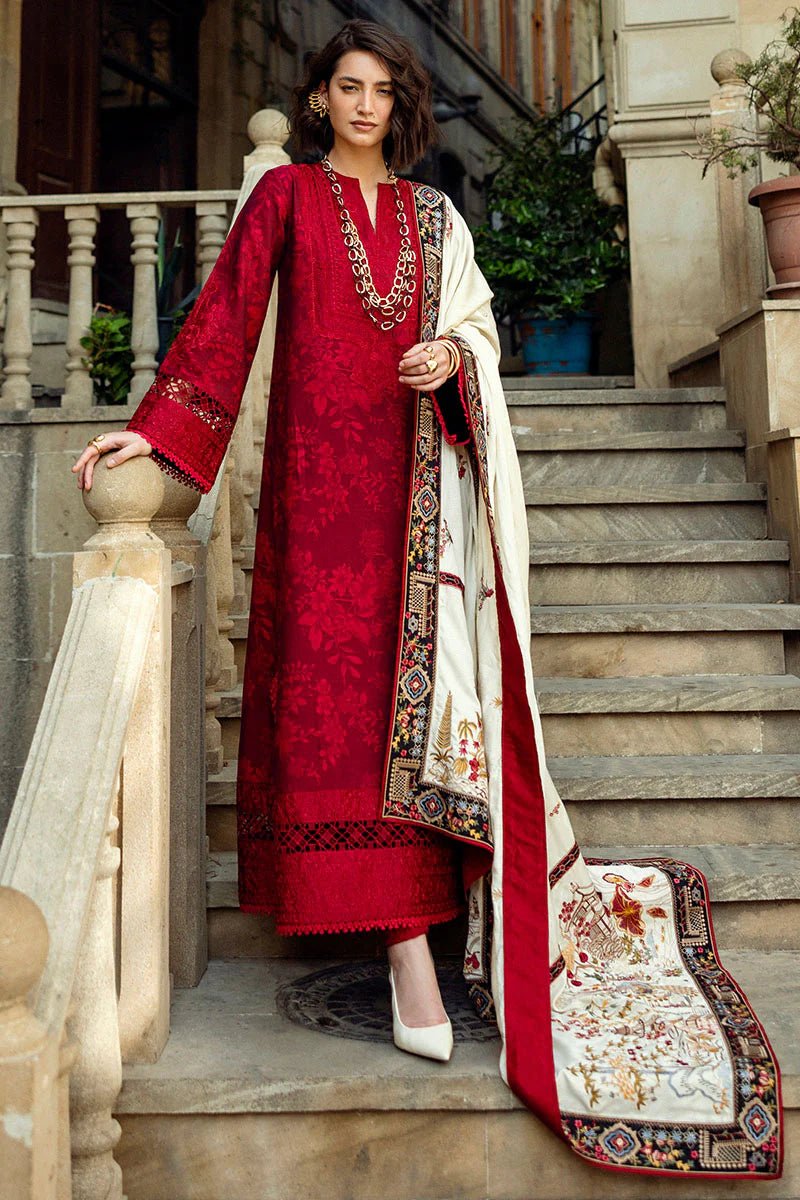 Model wearing Mushq Broadway A Walk to Remember Flying Kiss, a rich red dress with intricate patterns and a cream shawl, ideal for winter casual wear. Available for Pakistani clothes online in the UK.