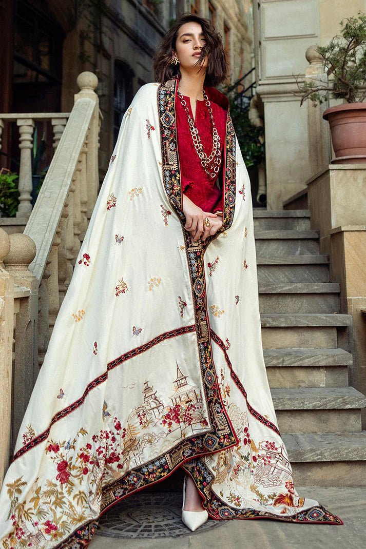 Model wearing Mushq Broadway A Walk to Remember Flying Kiss, a rich red dress with intricate patterns and a cream shawl, ideal for winter casual wear. Available for Pakistani clothes online in the UK.