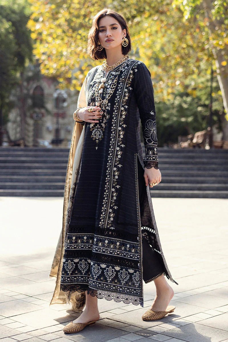 Model wearing Mushq Broadway A Walk to Remember Twisted Affection, a navy dress with intricate embroidery and a beige printed shawl, ideal for winter casual wear. Available for Pakistani clothes online in the UK.