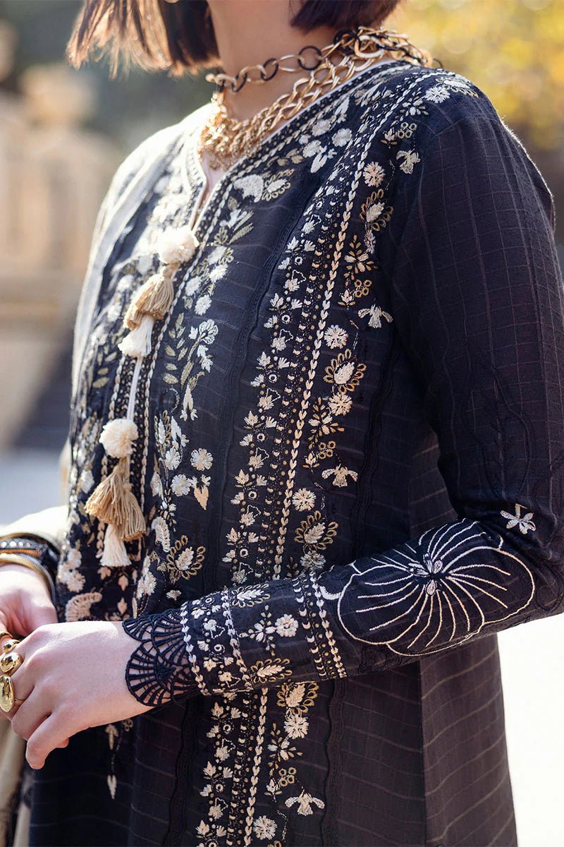 Model wearing Mushq Broadway A Walk to Remember Twisted Affection, a navy dress with intricate embroidery and a beige printed shawl, ideal for winter casual wear. Available for Pakistani clothes online in the UK.