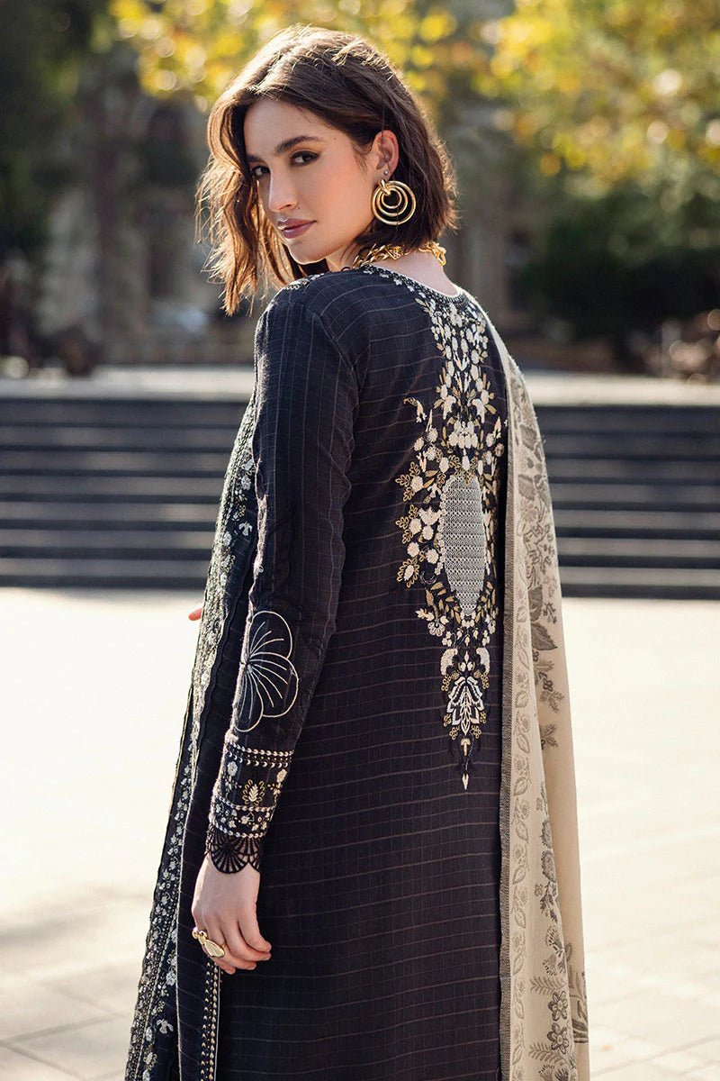 Model wearing Mushq Broadway A Walk to Remember Twisted Affection, a navy dress with intricate embroidery and a beige printed shawl, ideal for winter casual wear. Available for Pakistani clothes online in the UK.