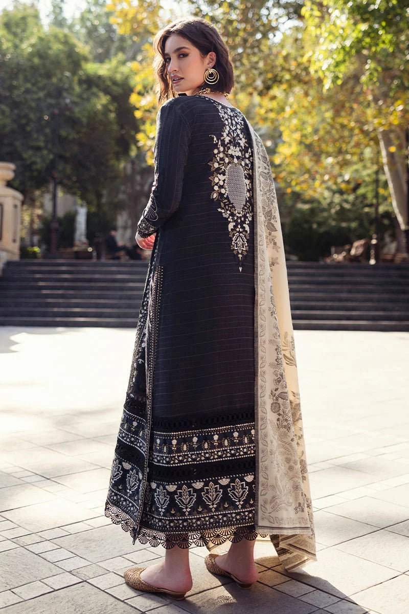 Model wearing Mushq Broadway A Walk to Remember Twisted Affection, a navy dress with intricate embroidery and a beige printed shawl, ideal for winter casual wear. Available for Pakistani clothes online in the UK.