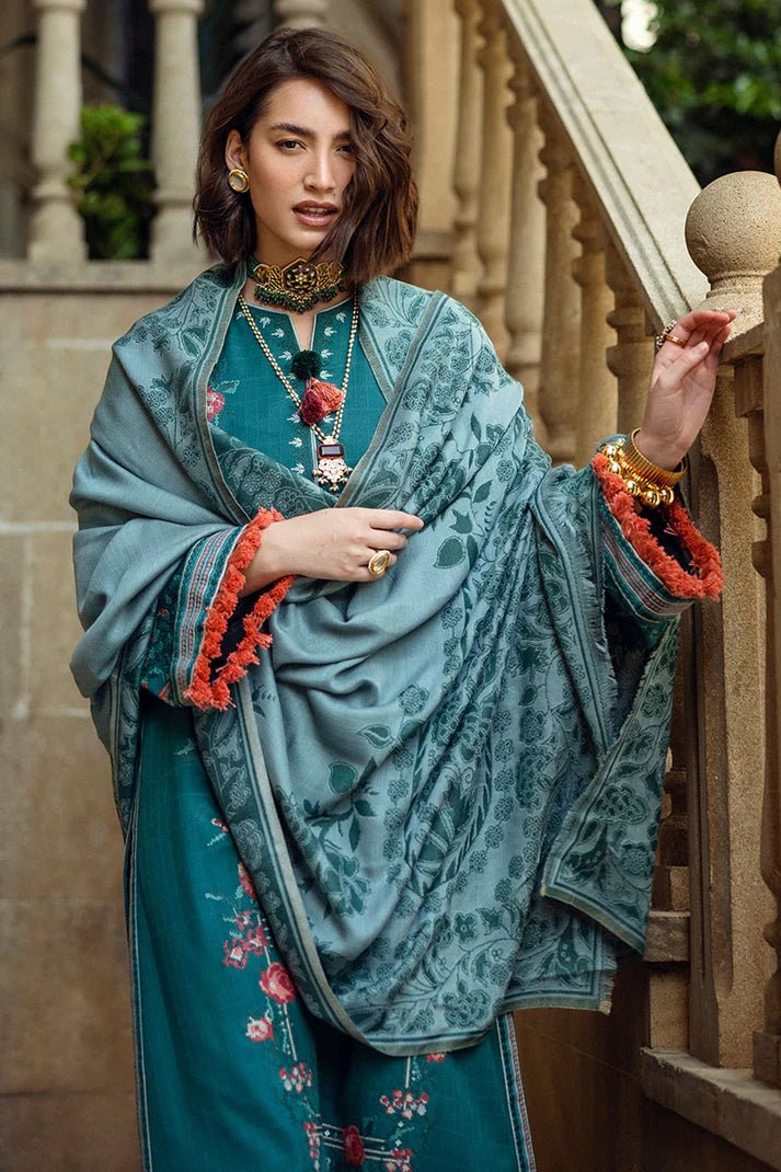 Model wearing Mushq Broadway A Walk to Remember Whispered Secrets, a teal dress adorned with floral embroidery and tassel accents, perfect for winter casual wear. Available for Pakistani clothes online in the UK.