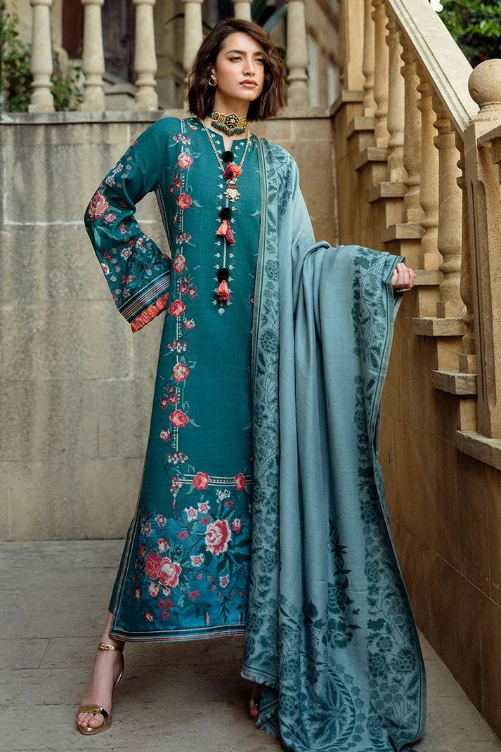 Model wearing Mushq Broadway A Walk to Remember Whispered Secrets, a teal dress adorned with floral embroidery and tassel accents, perfect for winter casual wear. Available for Pakistani clothes online in the UK.