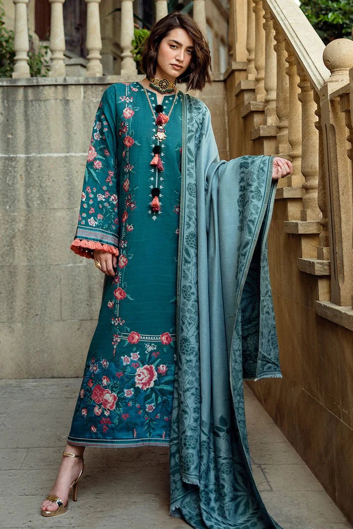 Model wearing Mushq Broadway A Walk to Remember Whispered Secrets, a teal dress adorned with floral embroidery and tassel accents, perfect for winter casual wear. Available for Pakistani clothes online in the UK.