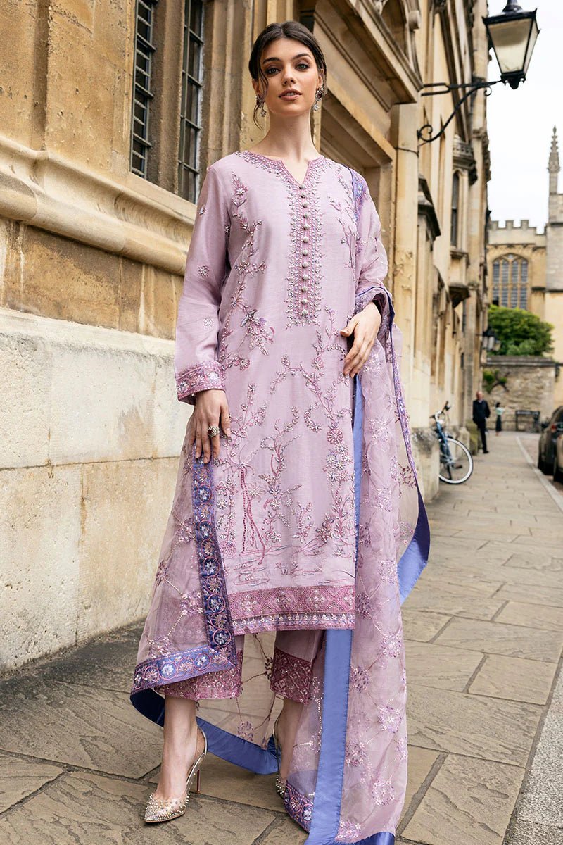 Model wearing a blue Aurora Bloom dress from Mushq. Features intricate floral embroidery, paired with matching pants and dupatta, showcasing Pakistani clothes online in the UK, wedding clothes.