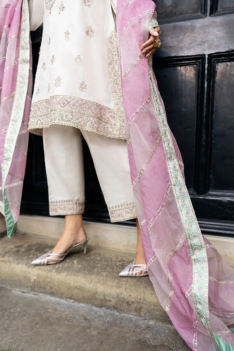 Model wearing a white Luminous Lace dress with intricate embroidery and a lavender dupatta from Mushq, perfect for weddings. Available for Pakistani clothes online in the UK.