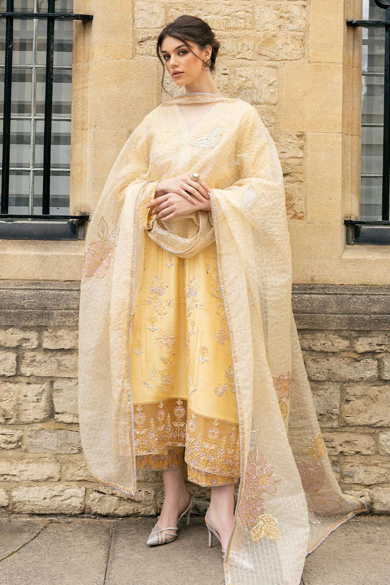 Model wearing a yellow Lyravia dress from Mushq, featuring intricate floral embroidery. Keywords: Mushq, Pakistani clothes online in UK, wedding clothes.