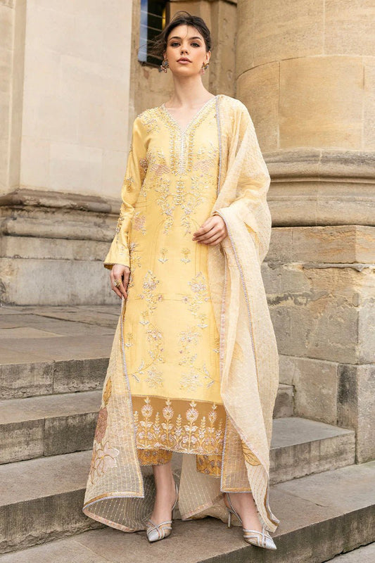 Model wearing a yellow Lyravia dress from Mushq, featuring intricate floral embroidery. Keywords: Mushq, Pakistani clothes online in UK, wedding clothes.