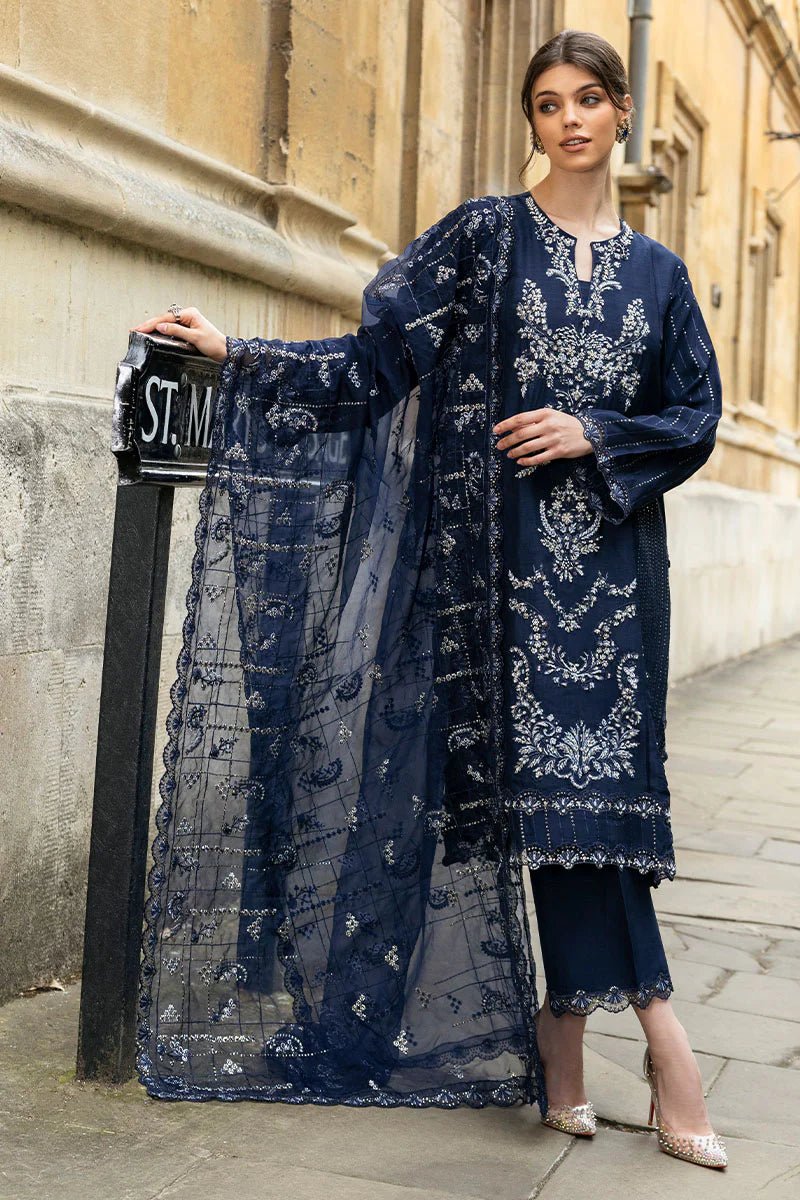 Model wearing Mushq Celestine The Oxford Edit 24 Starlight dress, featuring intricate embroidery and embellishments in a deep navy color. Perfect for wedding attire, available for Pakistani clothes online in the UK.