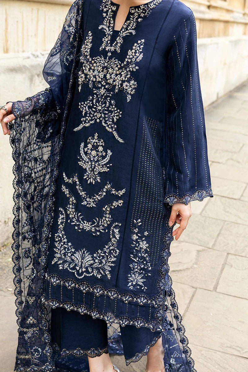 Model wearing Mushq Celestine The Oxford Edit 24 Starlight dress, featuring intricate embroidery and embellishments in a deep navy color. Perfect for wedding attire, available for Pakistani clothes online in the UK.