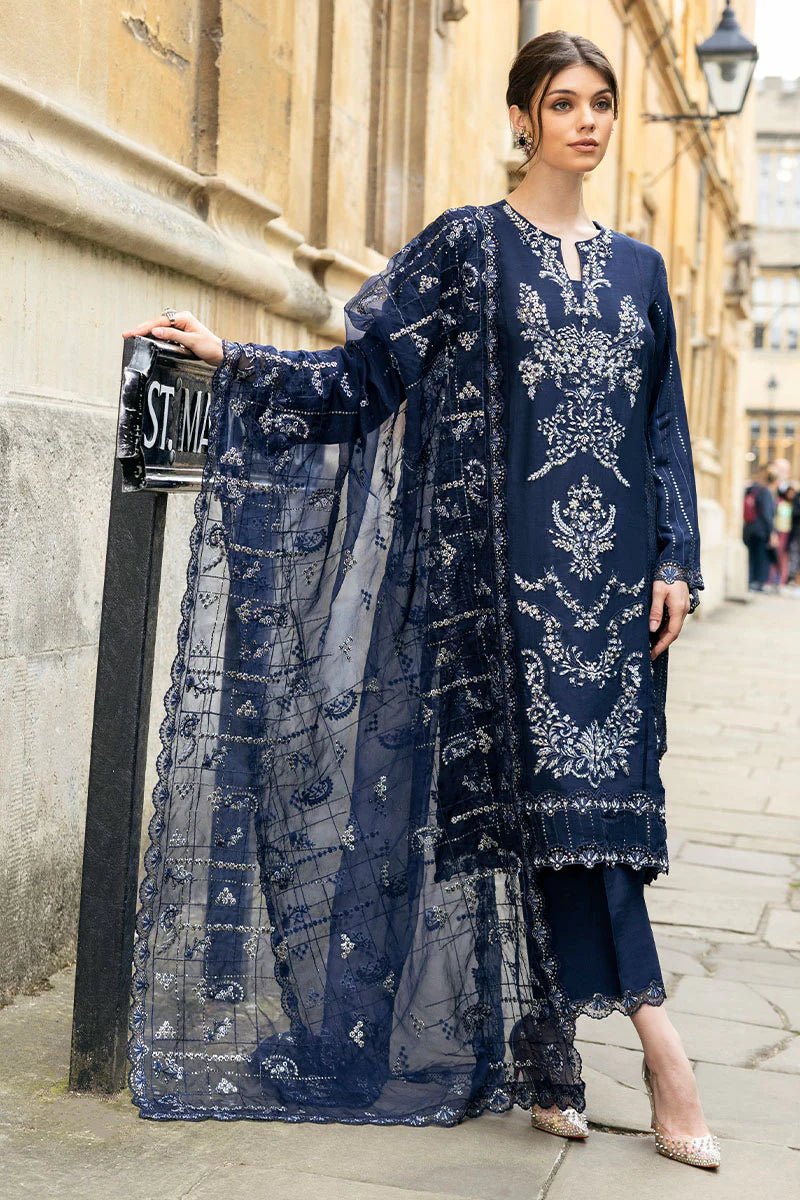 Model wearing Mushq Celestine The Oxford Edit 24 Starlight dress, featuring intricate embroidery and embellishments in a deep navy color. Perfect for wedding attire, available for Pakistani clothes online in the UK.