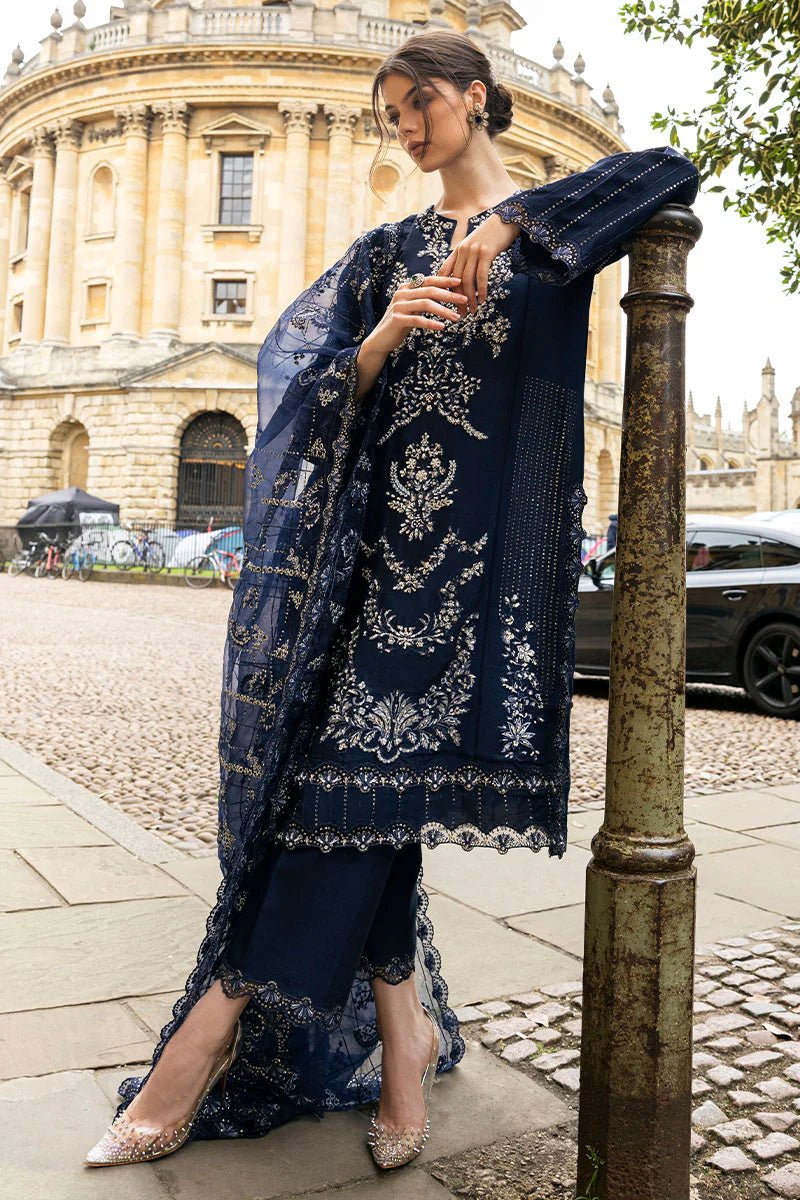 Model wearing Mushq Celestine The Oxford Edit 24 Starlight dress, featuring intricate embroidery and embellishments in a deep navy color. Perfect for wedding attire, available for Pakistani clothes online in the UK.