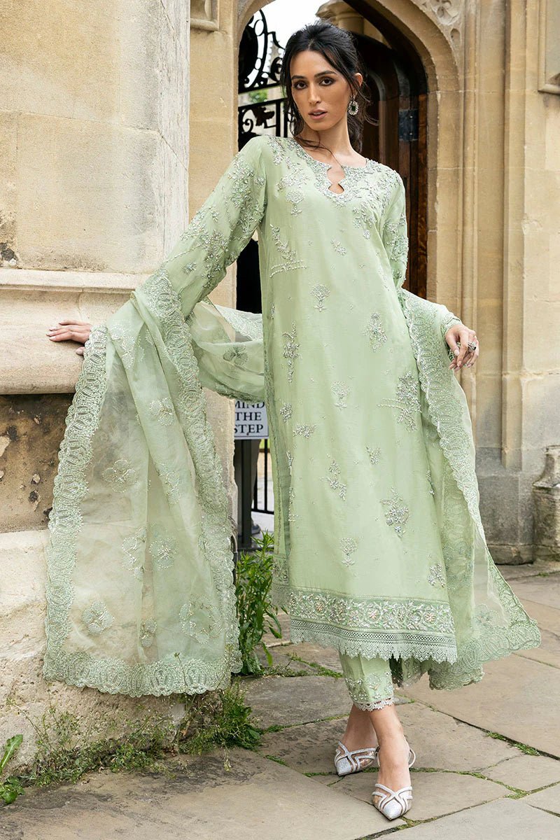 Model wearing a green Stella Grace dress from Mushq. Features intricate embroidery, paired with matching pants and dupatta, showcasing Pakistani clothes online in the UK, wedding clothes.