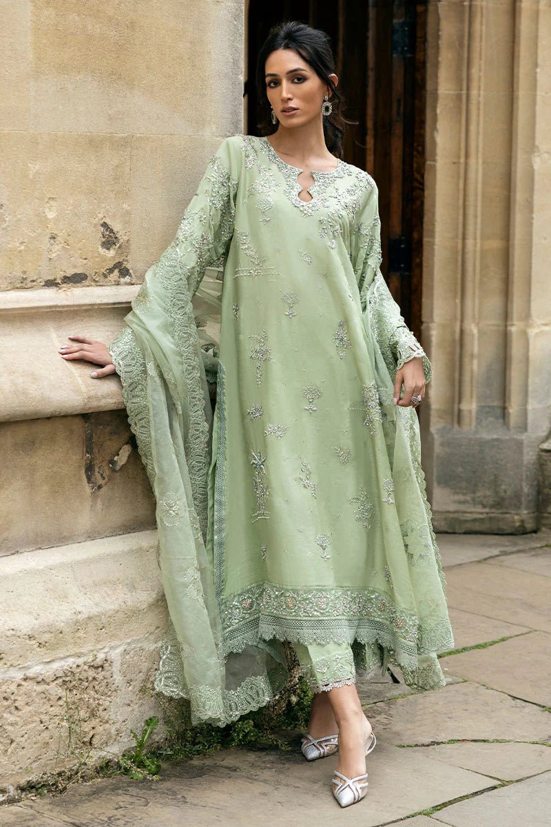 Model wearing a green Stella Grace dress from Mushq. Features intricate embroidery, paired with matching pants and dupatta, showcasing Pakistani clothes online in the UK, wedding clothes.