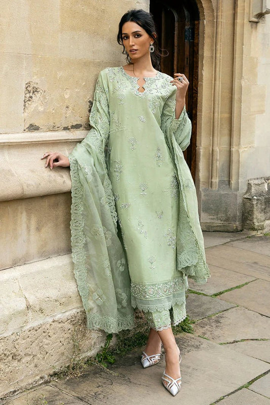 Model wearing a green Stella Grace dress from Mushq. Features intricate embroidery, paired with matching pants and dupatta, showcasing Pakistani clothes online in the UK, wedding clothes.