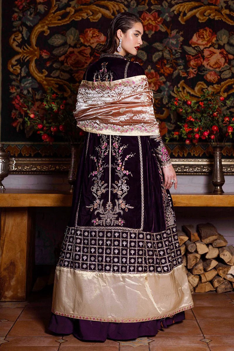 Model wearing Mushq DEJA VU - VELVET '24 Chasing Reflections, a deep purple velvet gown with intricate gold and silver embroidery, paired with a luxurious golden shawl. Perfect for winter weddings, available for Pakistani clothes online in the UK.