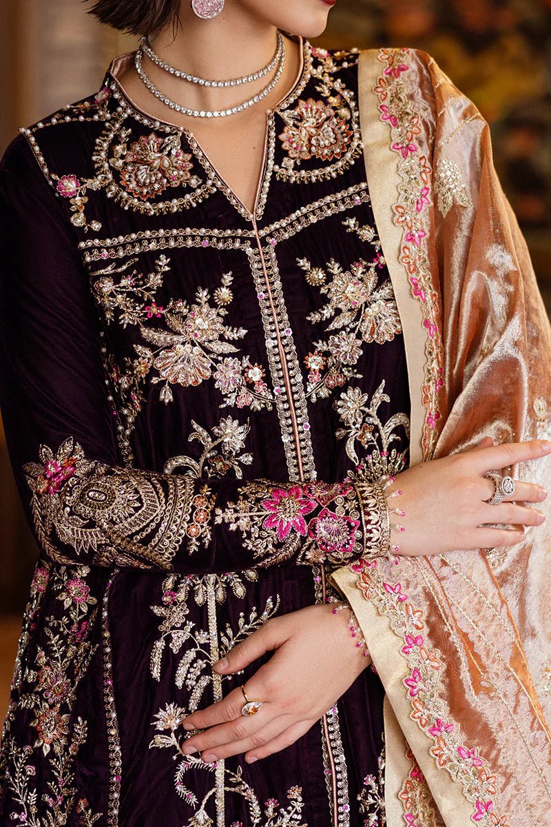 Model wearing Mushq DEJA VU - VELVET '24 Chasing Reflections, a deep purple velvet gown with intricate gold and silver embroidery, paired with a luxurious golden shawl. Perfect for winter weddings, available for Pakistani clothes online in the UK.