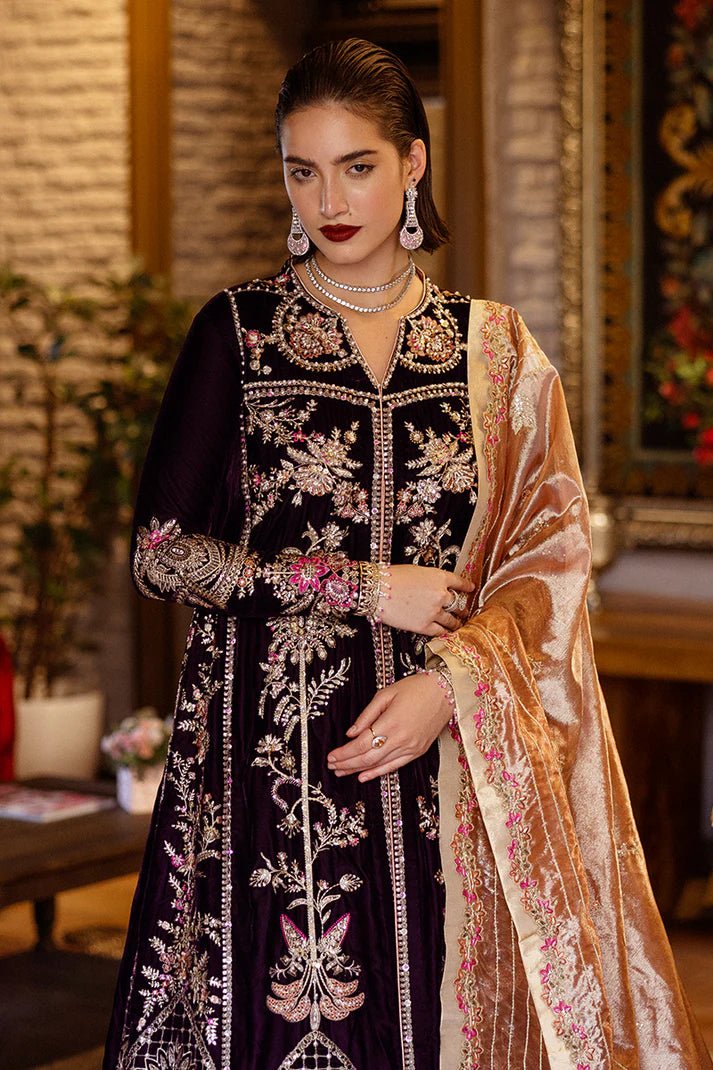 Model wearing Mushq DEJA VU - VELVET '24 Chasing Reflections, a deep purple velvet gown with intricate gold and silver embroidery, paired with a luxurious golden shawl. Perfect for winter weddings, available for Pakistani clothes online in the UK.