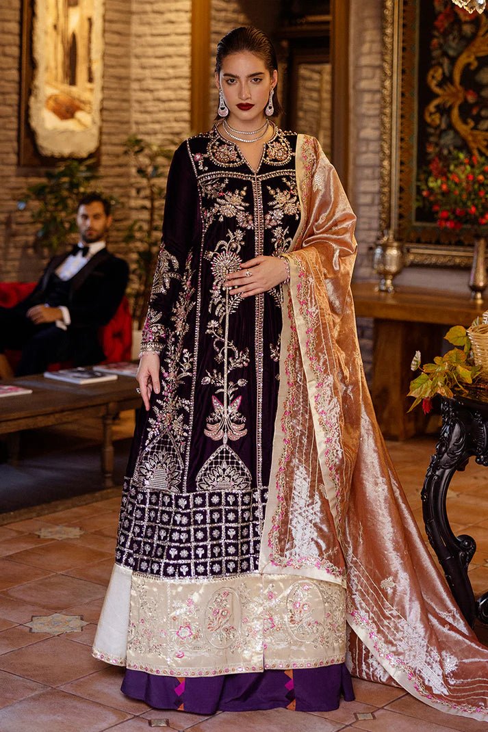 Model wearing Mushq DEJA VU - VELVET '24 Chasing Reflections, a deep purple velvet gown with intricate gold and silver embroidery, paired with a luxurious golden shawl. Perfect for winter weddings, available for Pakistani clothes online in the UK.