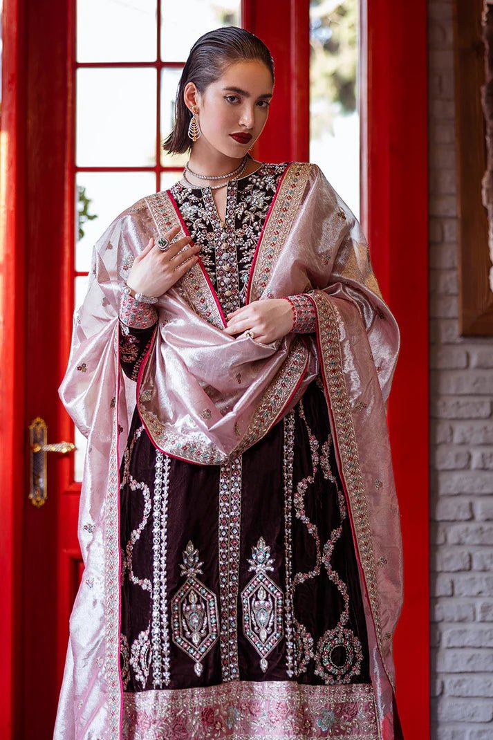 Model wearing Mushq DEJA VU - VELVET '24 Echoing Dreams, a deep maroon velvet outfit with intricate silver and pink embellishments, perfect for winter weddings. Available for Pakistani clothes online in the UK.