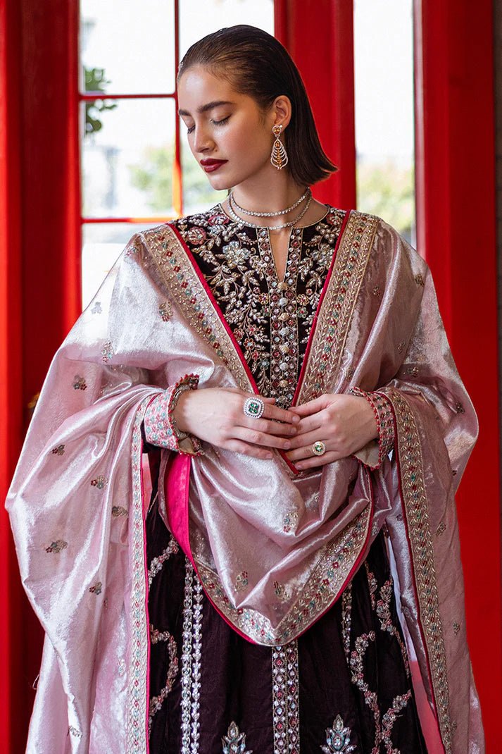 Model wearing Mushq DEJA VU - VELVET '24 Echoing Dreams, a deep maroon velvet outfit with intricate silver and pink embellishments, perfect for winter weddings. Available for Pakistani clothes online in the UK.