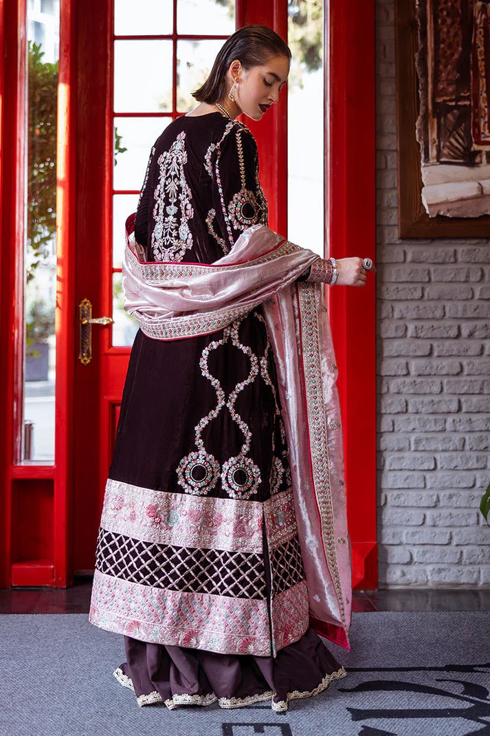 Model wearing Mushq DEJA VU - VELVET '24 Echoing Dreams, a deep maroon velvet outfit with intricate silver and pink embellishments, perfect for winter weddings. Available for Pakistani clothes online in the UK.