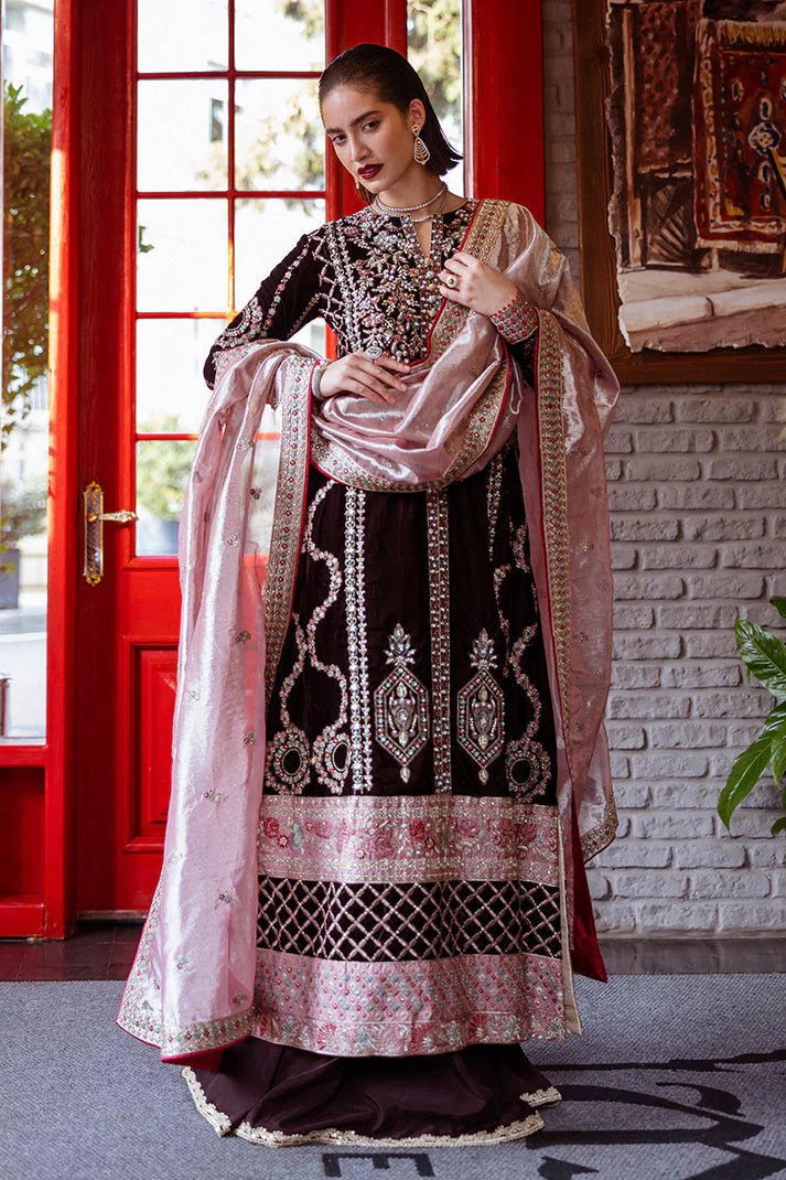 Model wearing Mushq DEJA VU - VELVET '24 Echoing Dreams, a deep maroon velvet outfit with intricate silver and pink embellishments, perfect for winter weddings. Available for Pakistani clothes online in the UK.